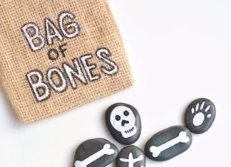 DIY Bag of Bones Halloween Painted Rocks Bag of bones Halloween painted rocks beside a labeled burlap bag