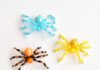 Step-by-Step Beaded Spider Tutorial for Halloween Colourful group of beaded spiders on a white background