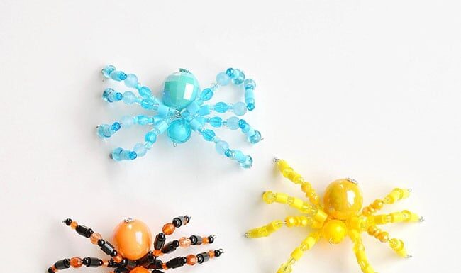 Step-by-Step Beaded Spider Tutorial for Halloween Colourful group of beaded spiders on a white background
