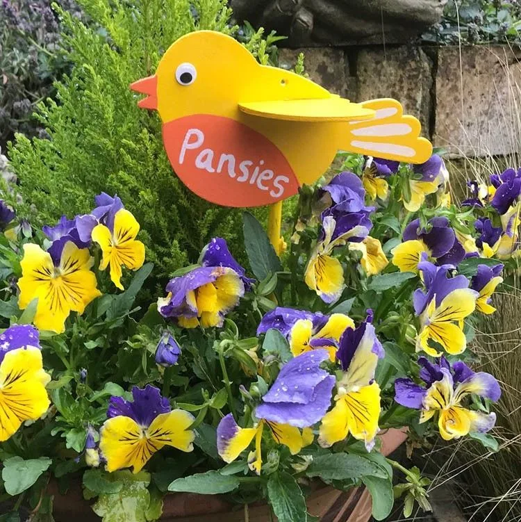DIY wooden bird flower stakes in garden