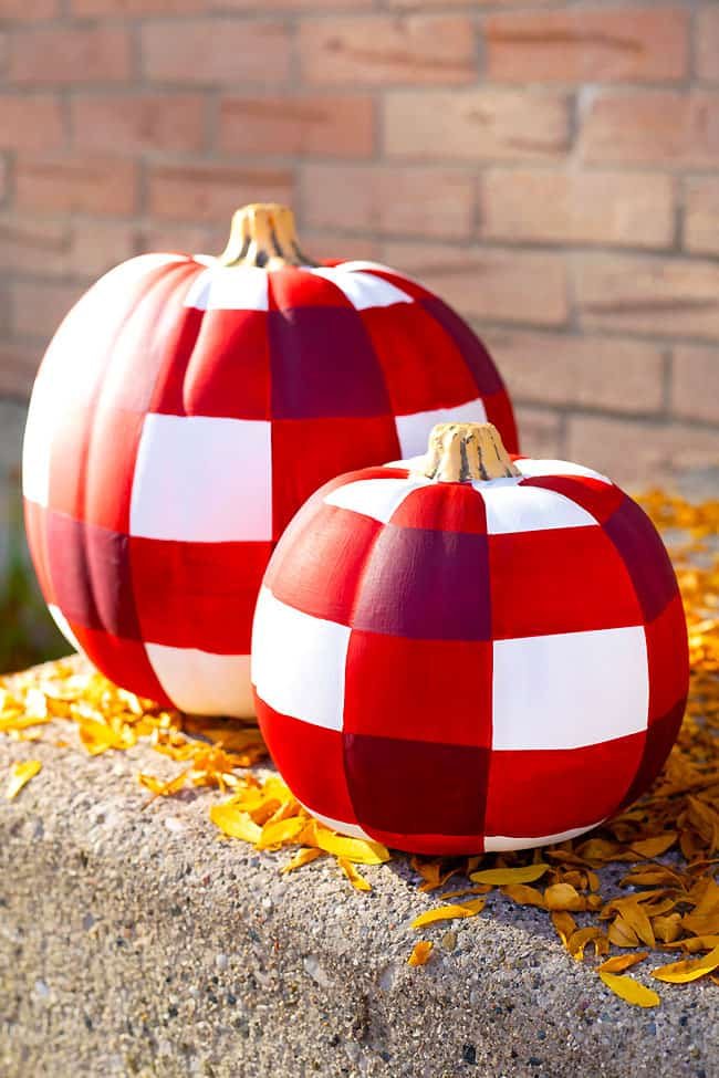 Buffalo plaid pumpkins on a porch