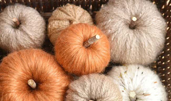 How to Make Chunky Yarn Pumpkins: Cozy Fall Decor Chunky yarn pumpkin in a basket with many others