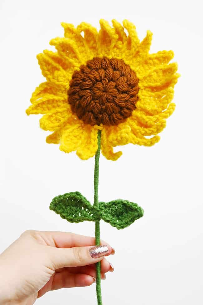 Holding a crochet sunflower