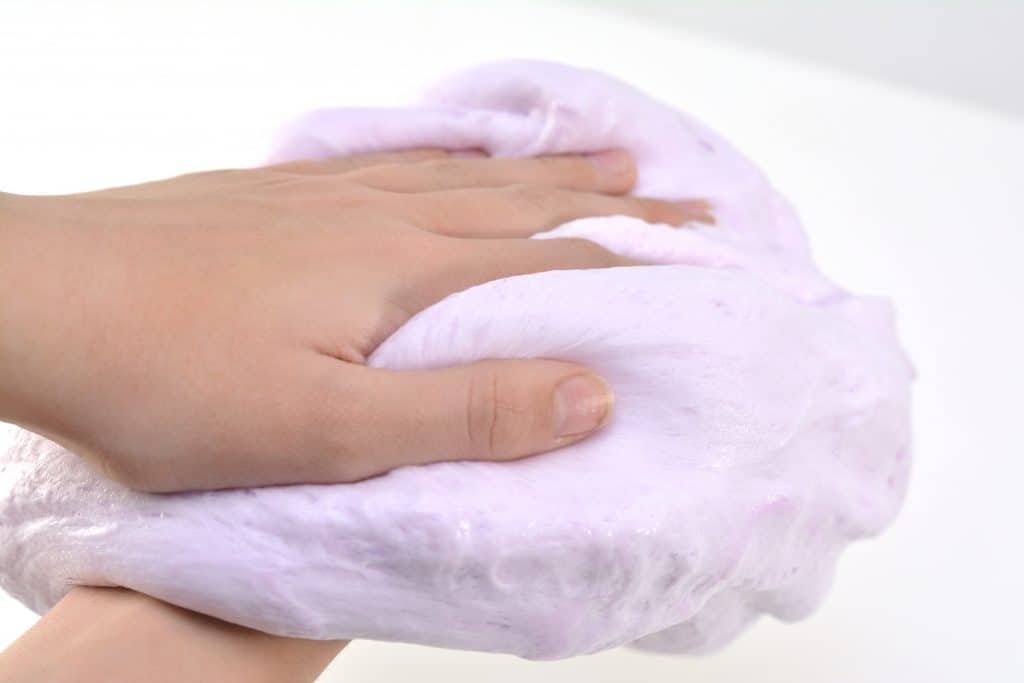 A close up of a hand and slime