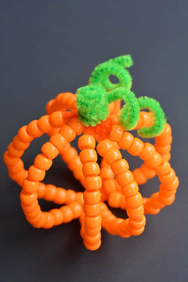 These beaded pipe cleaner pumpkins are SO ADORABLE! And they're really easy to make! All you need are two simple supplies that you can usually find at the dollar store. This is such a fun and simple kids craft that's super for Halloween and Thanksgiving. It’s a great activity for kids, teens, tweens, adults and seniors and a fun activity for October or fall/autumn in general.