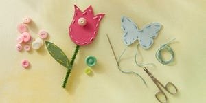 punch paper flowers and butterflies that are stitched with thread