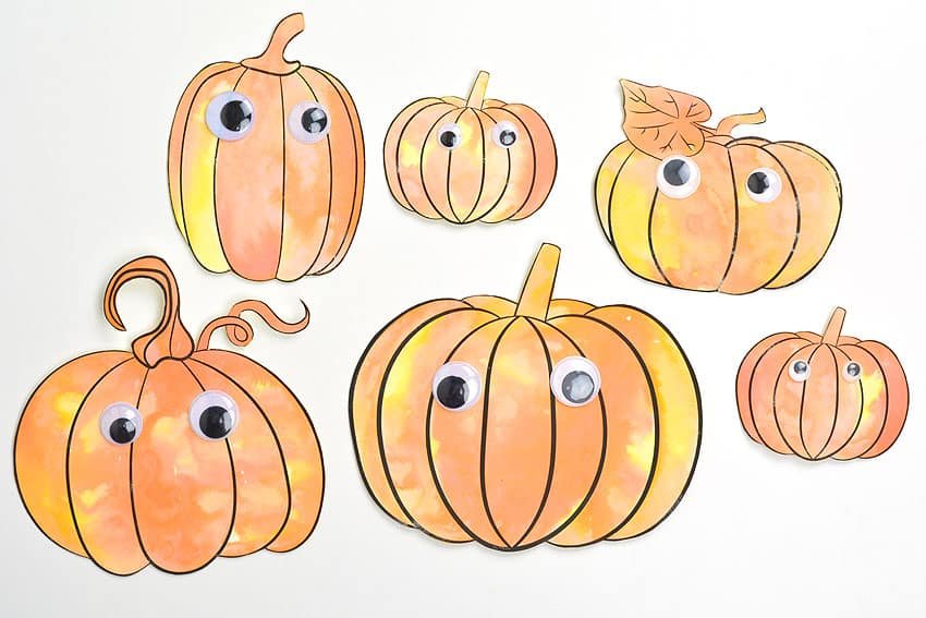 Six different pumpkins with googly eyes, painted with baking soda paint and vinegar