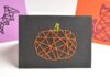 DIY Halloween String Art Cards: Fun Craft for All Ages A pumpkin Halloween string art card centered in frame