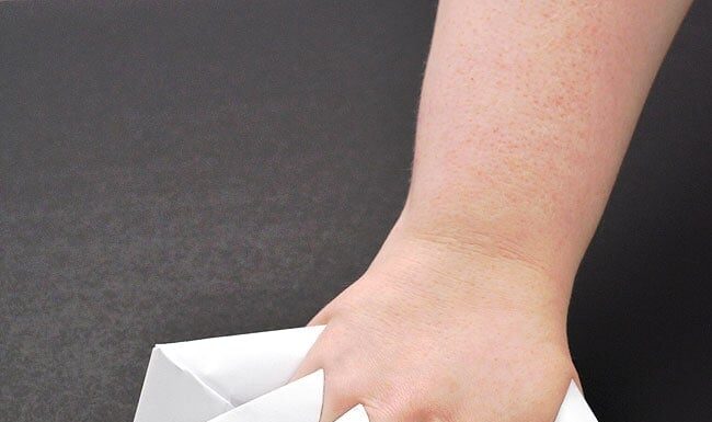 How to Make Paper Claws A hand wearing five folded paper claws