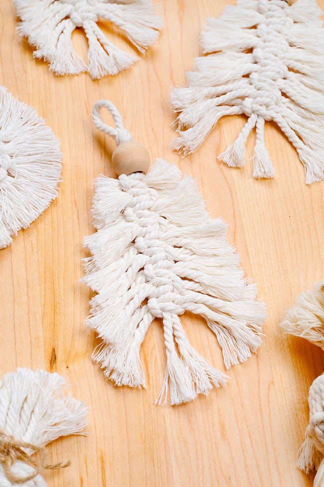 Macrame tree ornaments on a wooden background