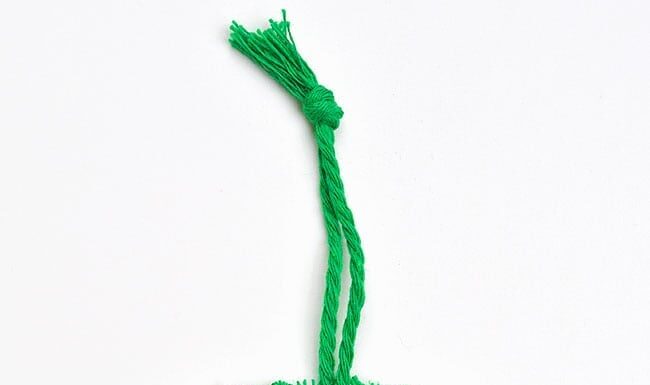 How to make Macrame Christmas Wreath Macrame Christmas wreath ornament on a white background