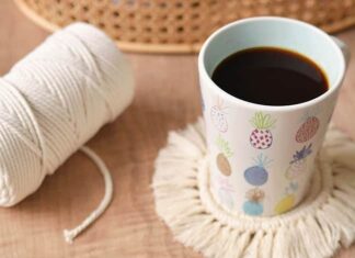 How to Make Macrame Coasters (Easy DIY Tutorial) Macrame coasters with cord and a coffee mug in the background