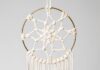 DIY Macrame Dream Catcher (Easy Boho Wall Decor) Macrame dream catcher on a gold hoop with wooden beads