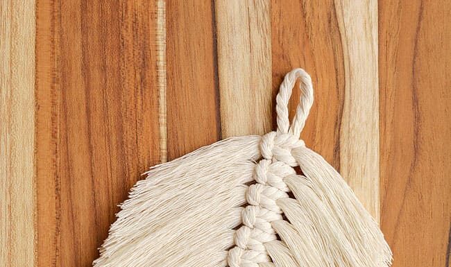 How to Make a Macrame Feather Macrame feather on a wooden background