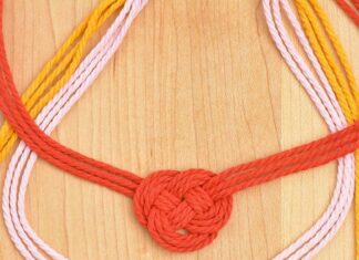 DIY Macrame Necklace Three Celtic heart macrame necklaces on a wooden background