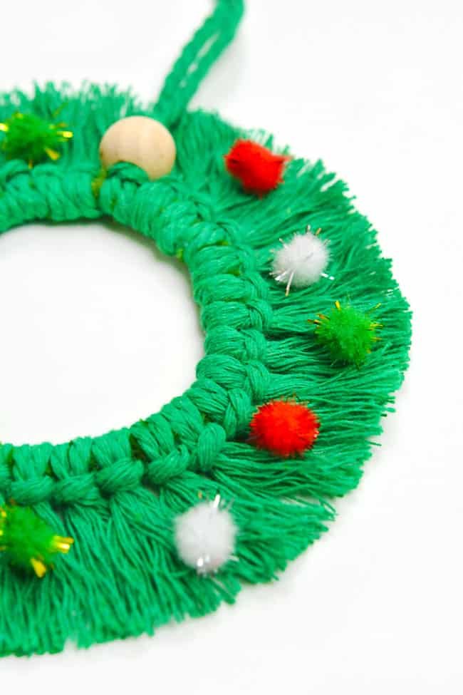 Close up of a green macrame wreath ornament