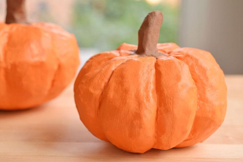 Paper mache pumpkins on a wooden surface