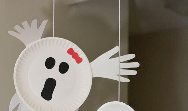 Easy Paper Plate Handprint Ghost Craft for Kids Paper plate ghosts hanging from the ceiling