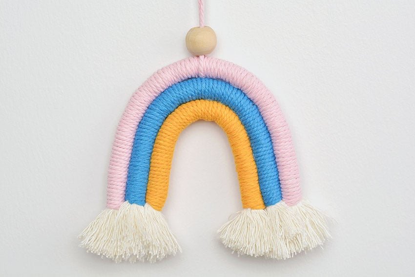 Closeup of a rainbow macrame wall hanging