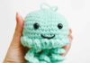 How to Crochet a Jellyfish: Step-by-Step Guide Holding a seafoam green crochet jellyfish