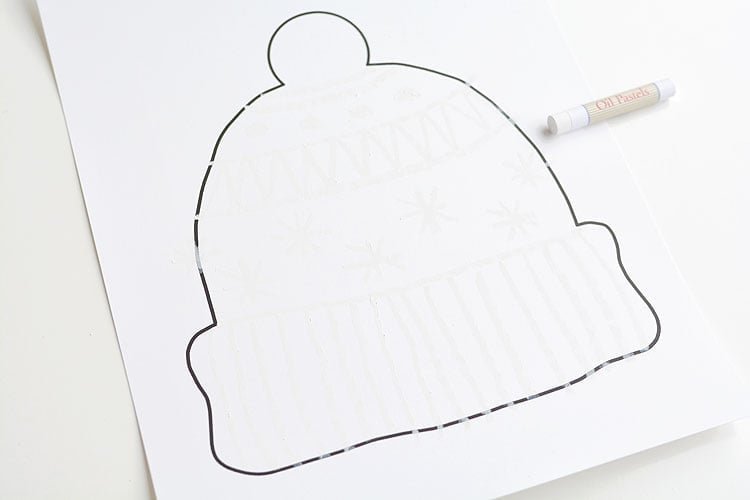 This winter hat art project for kids is such a fun winter craft idea! Use the free printable winter hat template to have a fun day of crafting at home or in the classroom! This process art idea lets you experiment with creating texture in watercolor and shows the magic of painting over crayon with watercolour paint! There's even instructions for making a DIY yarn pom pom!