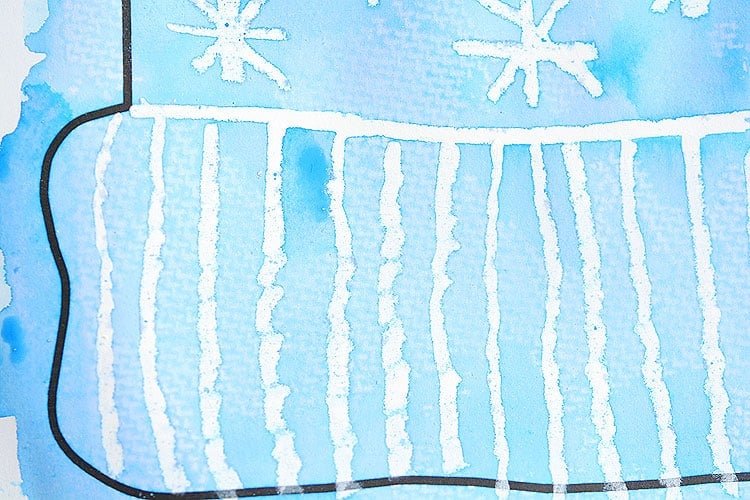 This winter hat art project for kids is such a fun winter craft idea! Use the free printable winter hat template to have a fun day of crafting at home or in the classroom! This process art idea lets you experiment with creating texture in watercolor and shows the magic of painting over crayon with watercolour paint! There's even instructions for making a DIY yarn pom pom!