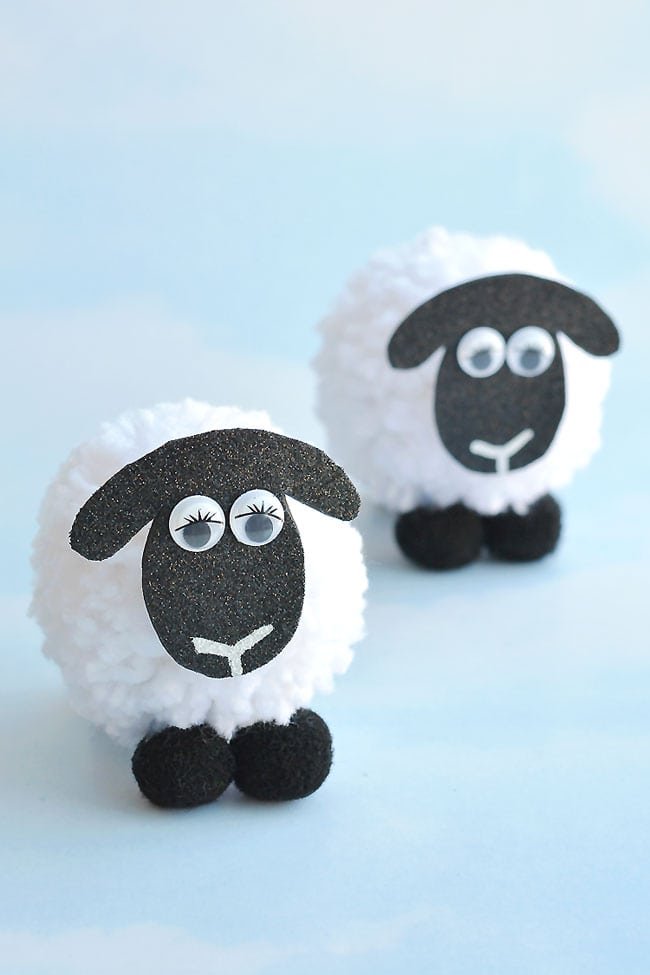 These pom pom sheep are SO CUTE and they're really simple to make! It's so easy to make DIY pom poms from yarn just by using your hands! This is such a fun kids craft for spring, or even Easter! I love that it uses such simple craft supplies. Pom pom crafts are the best!