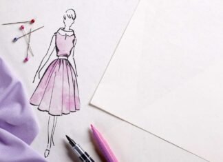 8 Best Fabric Markers for Cotton, Canvas, and T-Shirts in 2026 A hand using a Tulip Dual-Tip Fabric Marker to draw a vibrant floral design on a cotton T-shirt