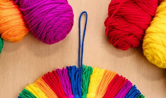 How to Make a Rainbow Tassel Wreath: DIY Craft Guide Rainbow tassel wreath made with colourful yarn