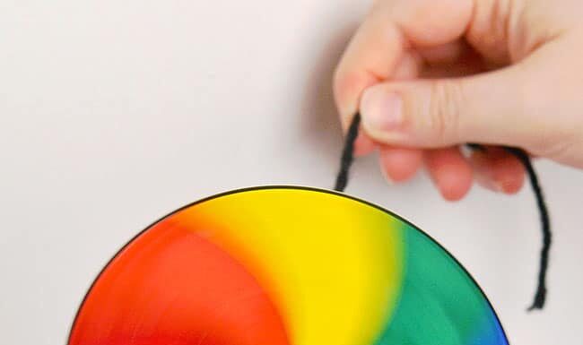 How to Make a String Spinner Toy: DIY Guide Rainbow coloured spinner toy twirling through the air