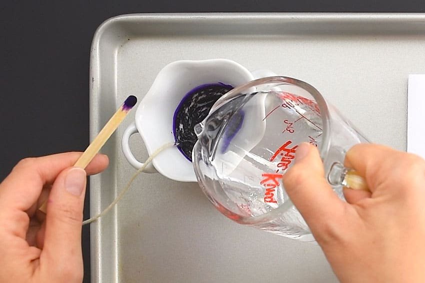 Pouring water into a bowl of paint