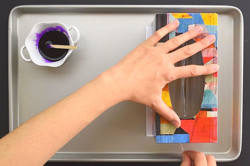 Tissue box on a piece of paper on a baking sheet