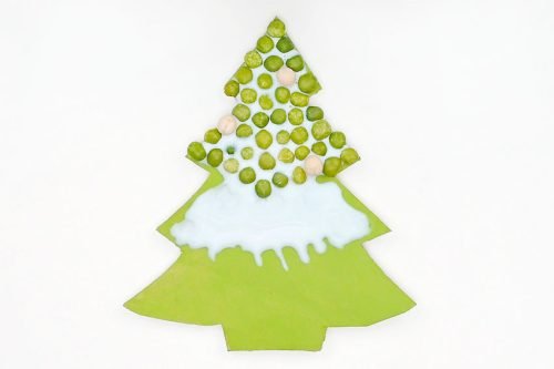 Green tree shape with white glue on top 2/3 and green peas on top 1/3