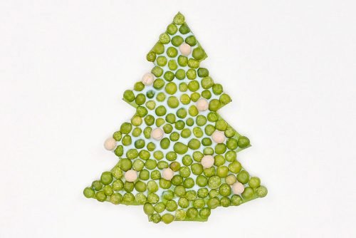 Tree shape covered in white glue with peas and lentils filling in the shape