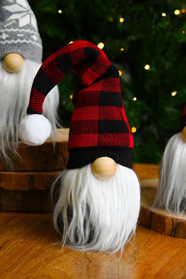 Christmas gnome with red plaid hat in front of gnome with grey snowflake hat