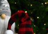 DIY Christmas Gnomes: Festive Handmade Decorations Christmas gnome with red plaid hat in front of gnome with grey snowflake hat