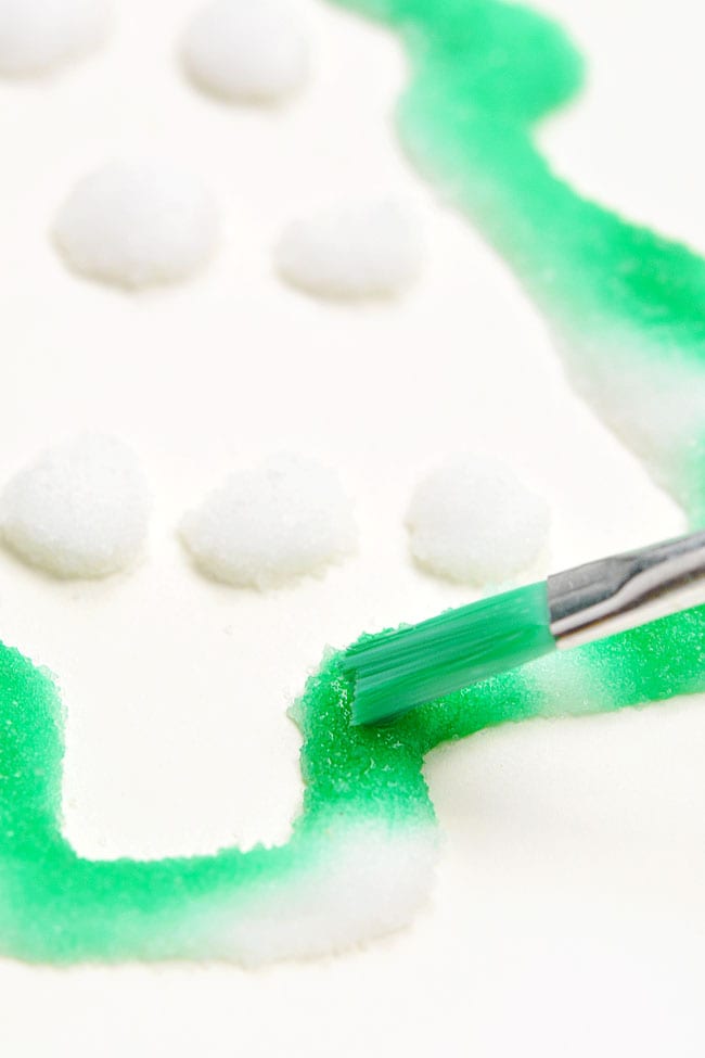 Christmas Salt Painting for Kids Closeup painting watercolor on salt Christmas tree outline