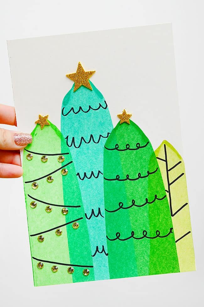 Holding a Christmas tree squeegee painting with glitter foam star toppers