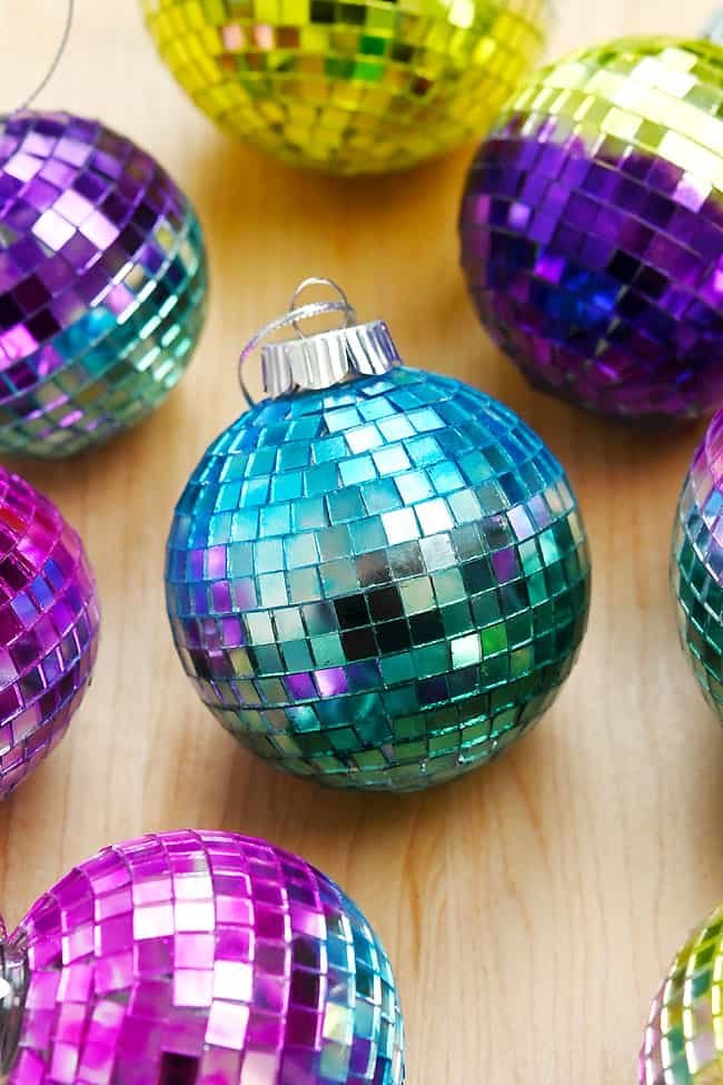 Disco ball ornament surrounded by other mirror ball ornaments