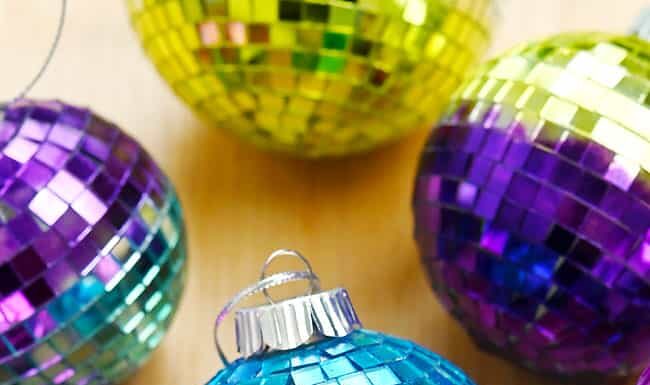 DIY Disco Ball Ornaments Disco ball ornament surrounded by other mirror ball ornaments