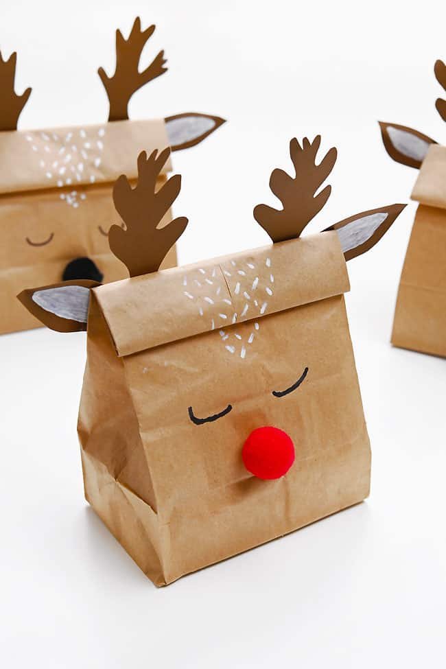 Group of DIY reindeer gift bags on a white background