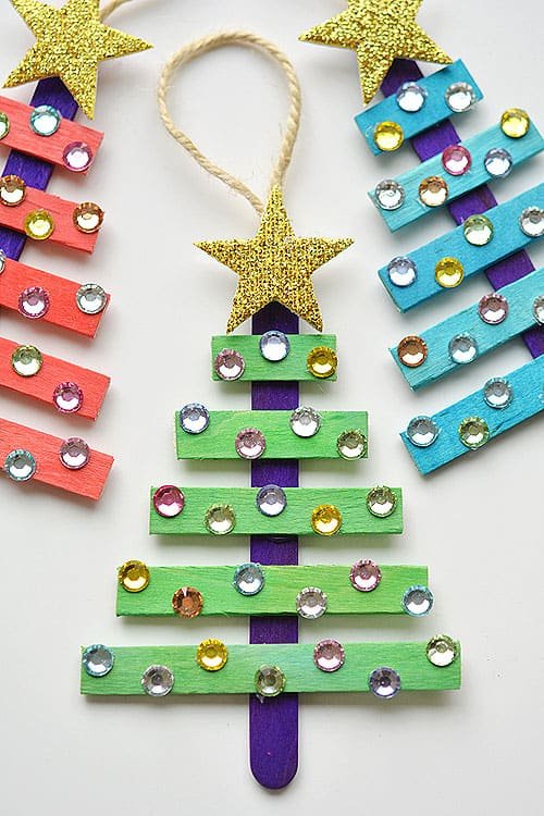 These popsicle stick Christmas trees are SO EASY to make and they're so beautiful! The kids loved decorating them! Such an awesome dollar store Christmas craft idea!!