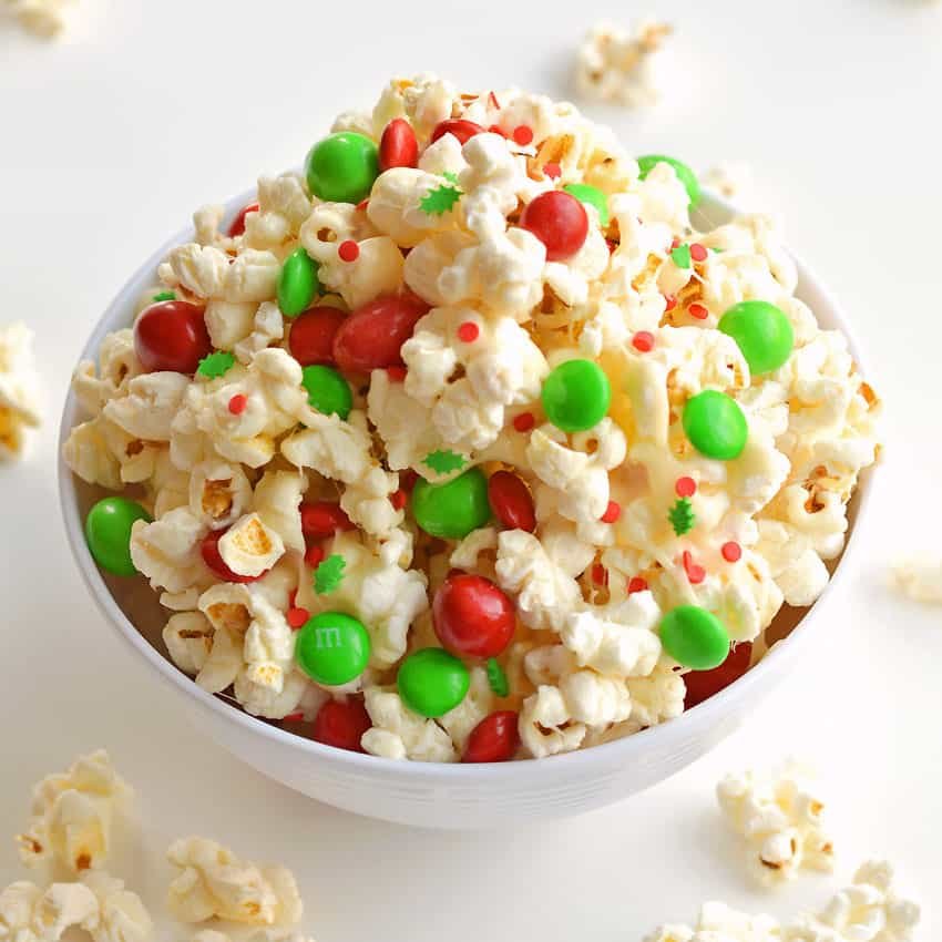 This marshmallow Christmas popcorn is SO GOOD and it's really simple to make. Such a great Christmas treat idea for kids and grown ups! I've also seen it called Santa Crunch Popcorn. Who knew marshmallow popcorn was a thing!? Top it with sprinkles and M&M's and this sweet and salty popcorn is delicious! (And perfect for the holidays!)