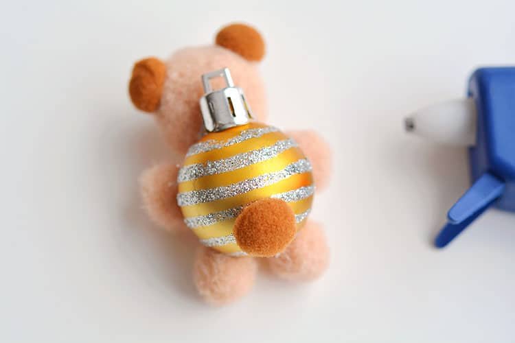 These pom pom teddy bear ornaments are ADORABLE for Christmas and they're super easy to make! All you need are dollar store pom poms and Christmas ball ornaments. This is such a fun dollar store kids craft idea for Christmas and a cute idea for homemade Christmas ornaments! Cutest little teddy bears ever!