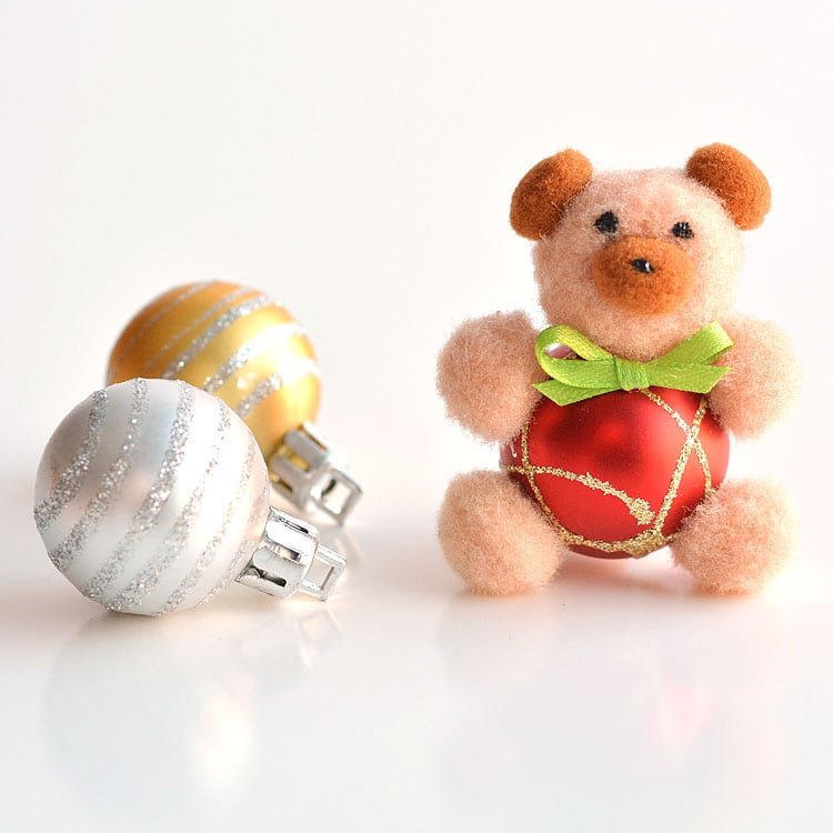 These pom pom teddy bear ornaments are ADORABLE for Christmas and they're super easy to make! All you need are dollar store pom poms and Christmas ball ornaments. This is such a fun dollar store kids craft idea for Christmas and a cute idea for homemade Christmas ornaments! Cutest little teddy bears ever!