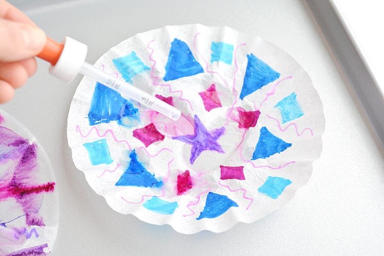 These coffee filter snowflakes are so easy to make and they are SO PRETTY! This is such a fun winter craft idea! A great activity for a snow day at home but also simple enough for teachers to make with the whole class at school. They make beautiful sun catchers and are a great Christmas decoration that can stay up all winter long! 