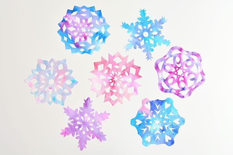 These coffee filter snowflakes are so easy to make and they are SO PRETTY! This is such a fun winter craft idea! A great activity for a snow day at home but also simple enough for teachers to make with the whole class at school. They make beautiful sun catchers and are a great Christmas decoration that can stay up all winter long! 