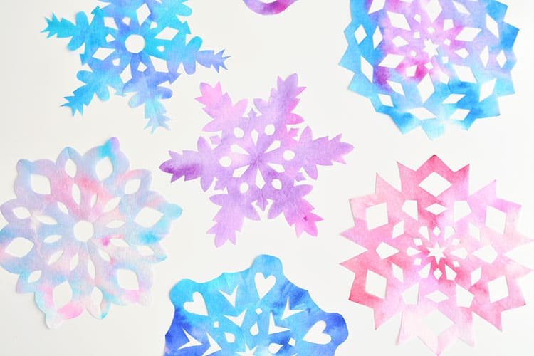 These coffee filter snowflakes are so easy to make and they are SO PRETTY! This is such a fun winter craft idea! A great activity for a snow day at home but also simple enough for teachers to make with the whole class at school. They make beautiful sun catchers and are a great Christmas decoration that can stay up all winter long! 