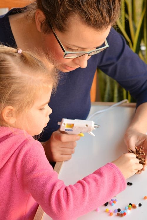 These pom pom and pinecone ornaments are SO EASY! They're a great craft for both kids and adults and they end up looking surprisingly beautiful!