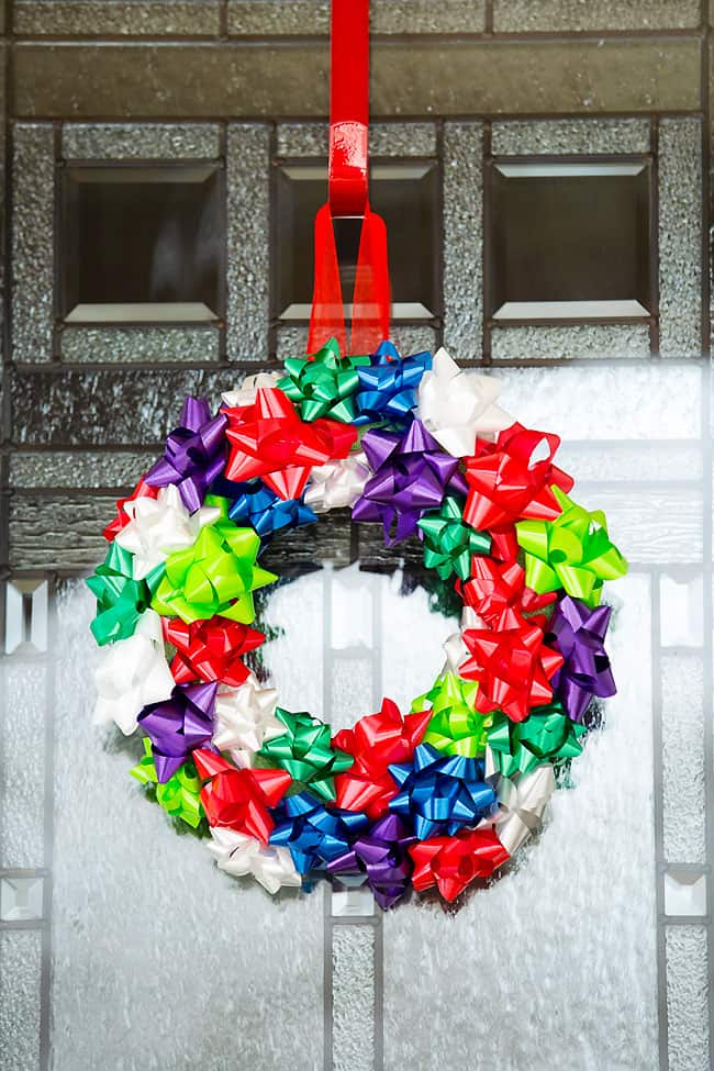 Christmas gift bow wreath hanging on a door